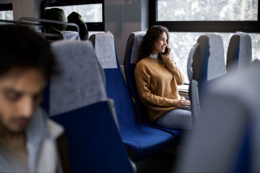 A woman talking on the phone in the bus