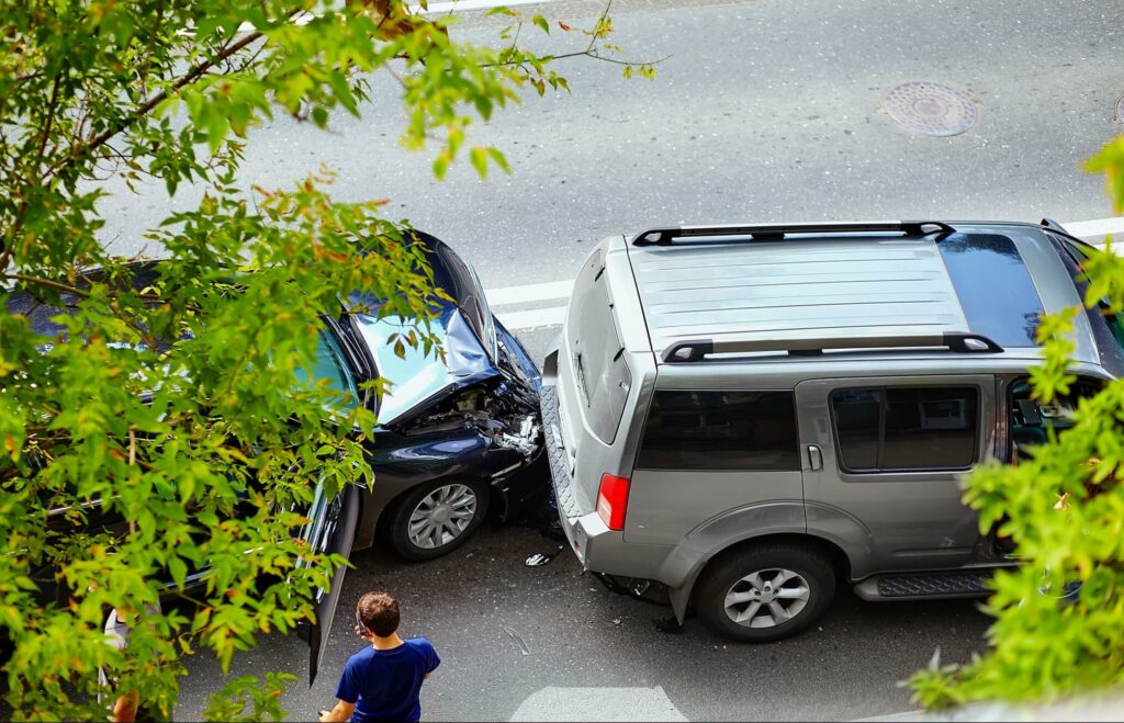 a car accident on the road involving a passenger car and an SUV