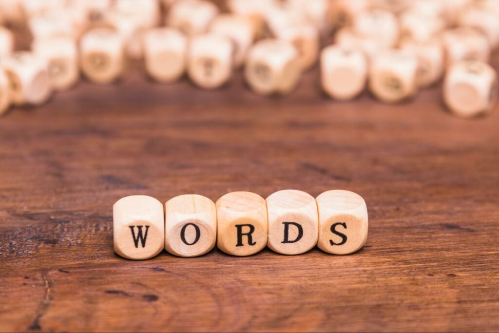 word text on wooden dice placed on a brown desk